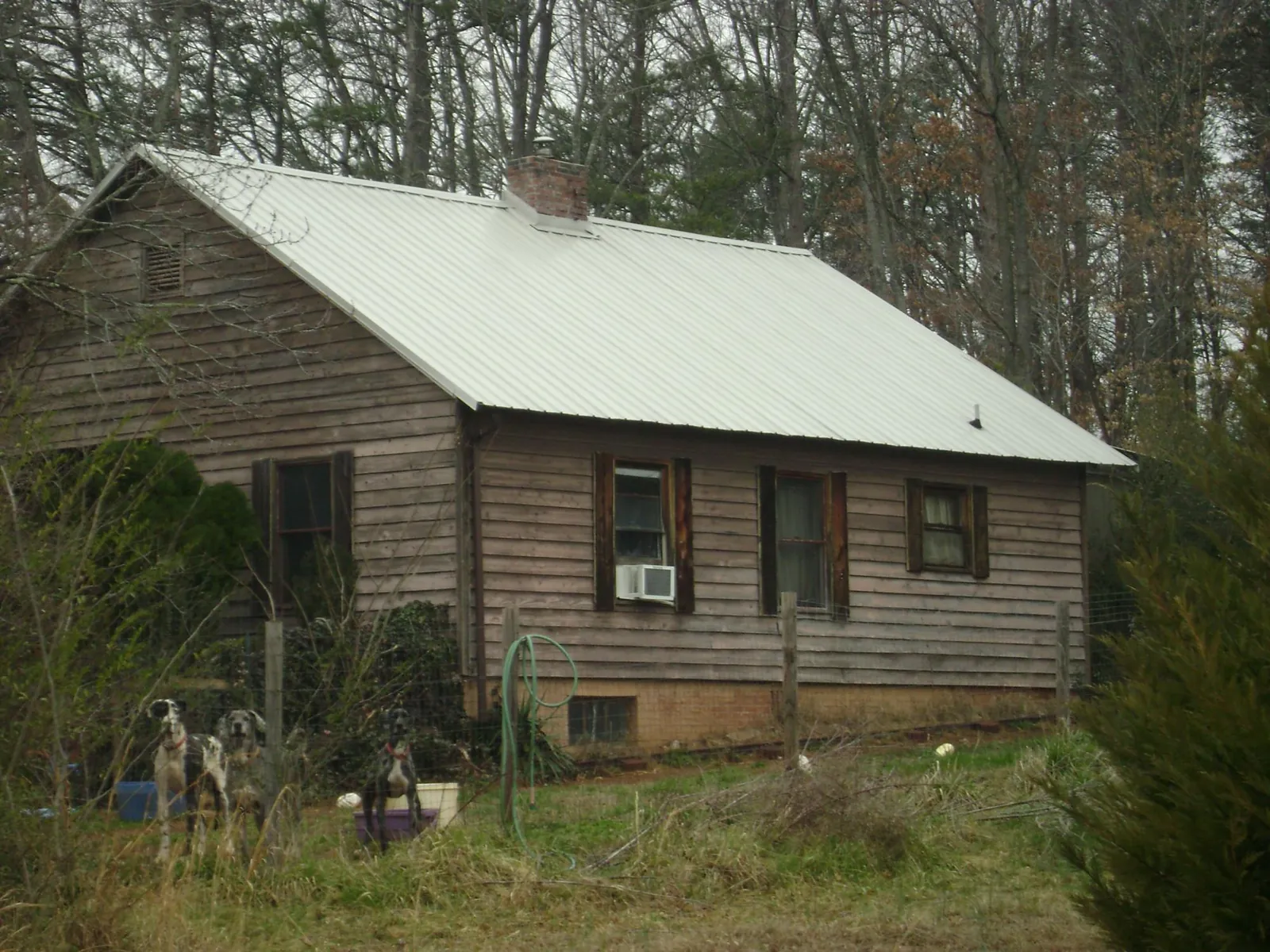 White metal roof on an old wood sided farmhouse, from a Metal Roof Installation job in Hickman